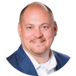 A smiling man with a light complexion, bald head, and short goatee wearing a blue blazer over a white shirt, posed confidently against a white background. Sourcing, Procurement, 3rd Party Risk