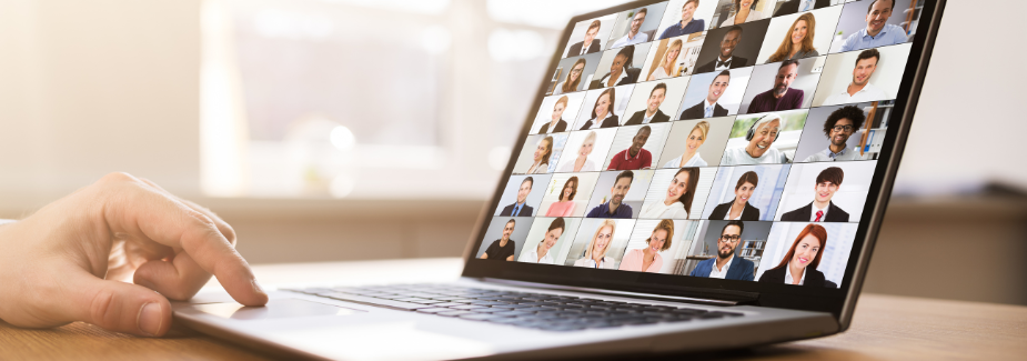 A person using a laptop to join an online meeting with many participants, each shown in their own small window on the screen. The laptop sits on a wooden table in a well-lit room. Sourcing, Procurement, 3rd Party Risk