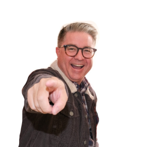 A smiling person with gray hair and glasses, wearing a brown jacket, confidently points at the camera against a white background. Sourcing, Procurement, 3rd Party Risk